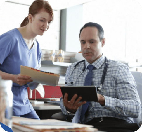 Healthcare administrator reviewing a report of insurance claim denials.